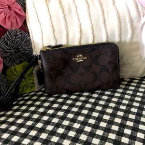 Brown and black Coach Wristlet